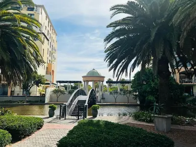 a park with a gazebo and a fountain and palm trees at 204 Island Club Luxury Apartment - Cape Town in Cape Town