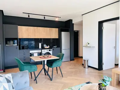 a kitchen and dining room with a table and chairs at Zals Luxury -Nine Palms in Cape Town