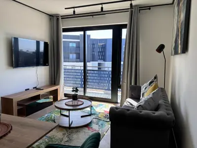 a living room with a couch and a table at Zals Luxury -Nine Palms in Cape Town