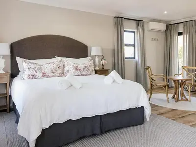 a large bedroom with a large white bed with pillows at Yonder Hill Accommodation in Raithby