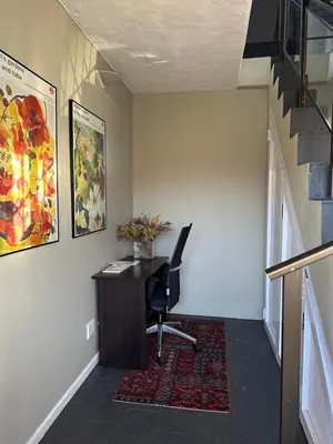 an office with a desk and a chair in a hallway at Central Retreat Cozy Apartment Near Attractions in Cape Town