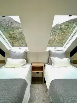 two beds in a room with two windows at The Unbound - Escape the Ordinary in Romansrivier