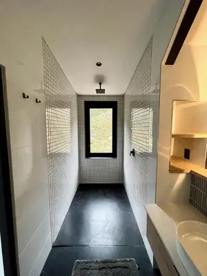 a bathroom with a walk in shower and a window at The Unbound - Escape the Ordinary in Romansrivier