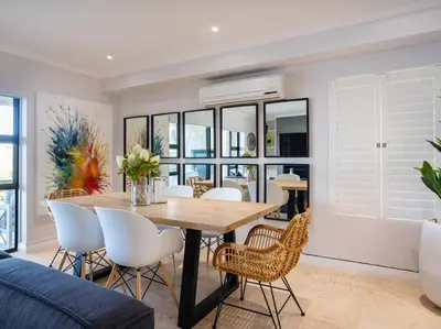 a dining room with a table and chairs at Luxury Lodge 5F, Pearl Valley Golf Estate in Paarl