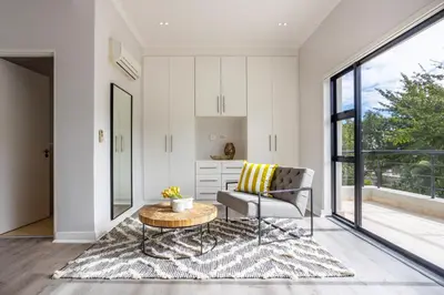 a living room with a couch and a table at Luxury Lodge 5F, Pearl Valley Golf Estate in Paarl