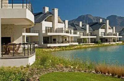 a large building with a lake in front of it at Luxury Lodge 5F, Pearl Valley Golf Estate in Paarl