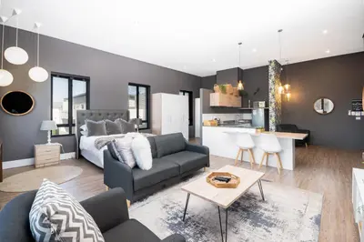 a living room with a couch and a kitchen at 309 on Titanium in Cape Town