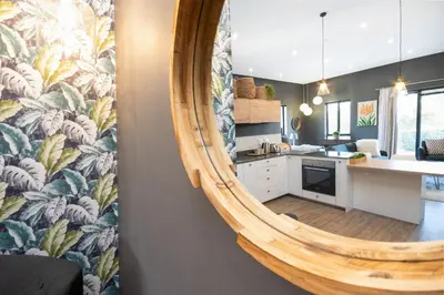 a kitchen with a large mirror on the wall at 309 on Titanium in Cape Town