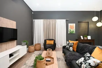 a living room with a couch and a tv at 309 on Titanium in Cape Town