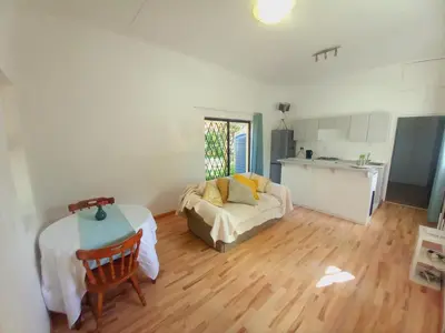 a living room with a couch and a table and a kitchen at The Haven Hide-Away in Fisherhaven