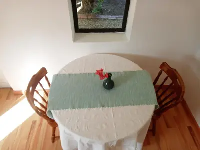 a table with two chairs and a vase on it at The Haven Hide-Away in Fisherhaven