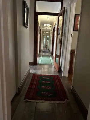 a hallway of a house with a rug on the floor at The Villa at Marnas Private Self-Catering Accommodation in Cape Town
