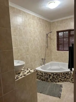 a bathroom with a tub and a sink at The Villa at Marnas Private Self-Catering Accommodation in Cape Town