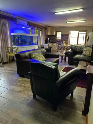 a living room with couches and a blue light at Marnas Private Self Catering Accommodation The Cottage in Cape Town