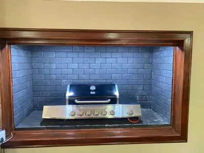 a toaster oven sitting inside of a brick fireplace at Marnas Private Self Catering Accommodation The Cottage in Cape Town