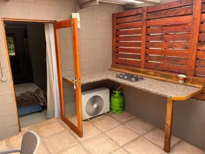 a kitchen with a sink and a microwave in a room at The Jack at Marnas Self Catering Accommodation in Cape Town