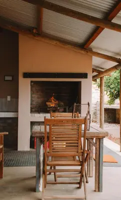 a wooden bench sitting in front of a fireplace at Dassenheuwel Farm Stay Cottages in Malmesbury