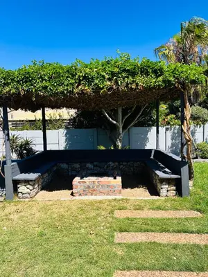 a bench sitting under a pavilion in a park at Private garden guest house in Cape Town