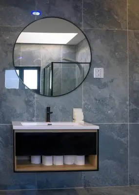 a bathroom with a sink and a mirror at FB-Canatal Luxury Apartments in Cape Town