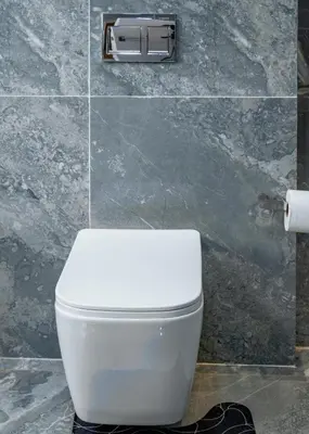 a white toilet in a bathroom with a tile wall at FB-Canatal Luxury Apartments in Cape Town