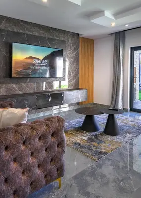 a living room with a tv and a couch and a table at FB-Canatal Luxury Apartments in Cape Town