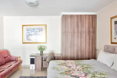 a bedroom with a bed and a couch at Goodwood Oasis FreeWiFi-Parking 1 in Cape Town