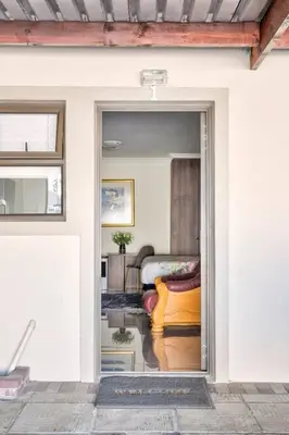 an open door to a living room with a couch at Goodwood Oasis FreeWiFi-Parking 1 in Cape Town