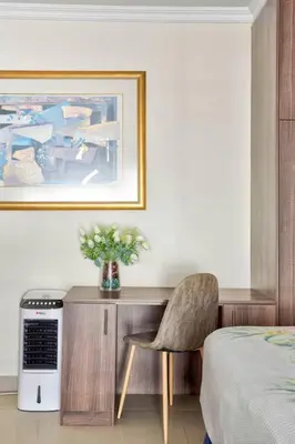 a bedroom with a desk with a chair and a bed at Goodwood Oasis FreeWiFi-Parking 1 in Cape Town