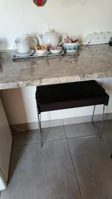 a counter with a bench sitting under a counter top at The Somerset nest in Cape Town