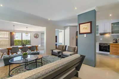 a living room with a couch and a table at Chic, Cozy, Modern, Secure and Centrally Located in Cape Town