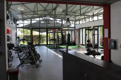 a gym with bikes and exercise equipment in a room at Sundown Apartment in Cape Town