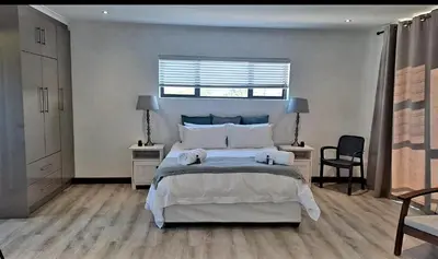 a bedroom with a large bed with two towels on it at Hermanus reefs in Hermanus