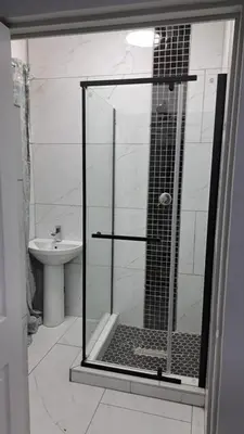 a shower with a glass door in a bathroom at Abyssinia Guest House in Cape Town