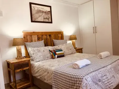 a bedroom with a bed with two towels on it at MELJAA GROUP Guesthouse in Cape Town