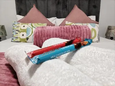 a bed with a red and blue at Cethone Luxury Guest House in Cape Town