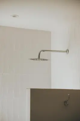 a bathroom with a light hanging from the wall at Sandown Synergy Lagoon House in Hermanus