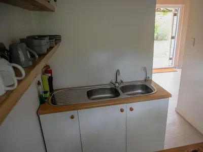 a kitchen with a sink and a counter at Cape Weaver cottage in Greyton