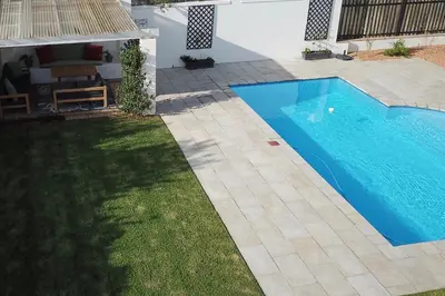 a swimming pool in the backyard of a house at Largest one bed apartment & private pool in the Hoek in Franschhoek