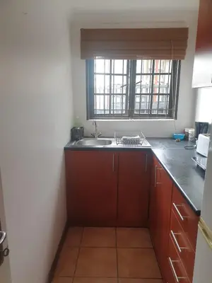 a kitchen with a sink and a window at Cape Cottage in Cape Town