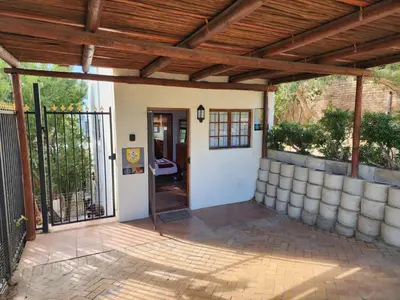 an entrance to a house with a wooden ceiling at Cape Cottage in Cape Town