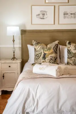 a bedroom with a bed with pillows and a night stand at Nantes-vue in Paarl