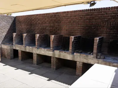 a brick wall with a bench in front of it at St Tropez Beachfront 306 in Strand