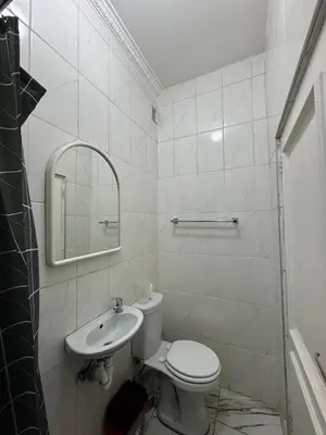 a white bathroom with a toilet and a sink at Michu Guest house in Cape Town