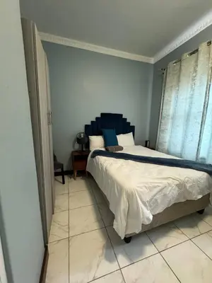 a bedroom with a large bed in a room at Michu Guest house in Cape Town