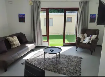 a living room with a couch and a coffee table at Claremont Studio in Cape Town