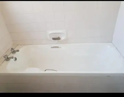 a bath tub with a sink in a bathroom at Claremont Studio in Cape Town