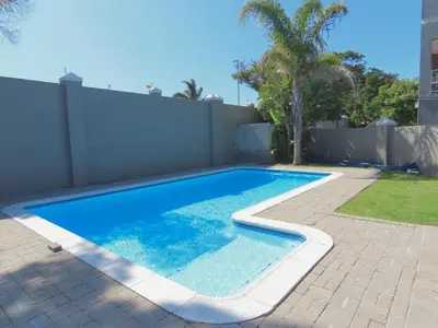 a swimming pool in a backyard with a fence at Smithland Centrally Located Accommodation in Cape Town