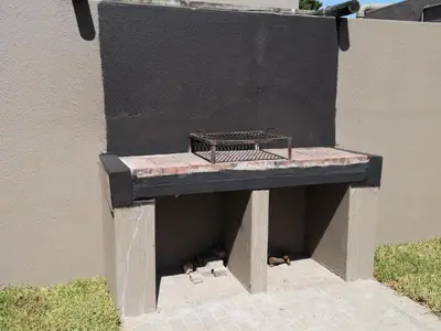a bench sitting on the side of a building at Smithland Centrally Located Accommodation in Cape Town