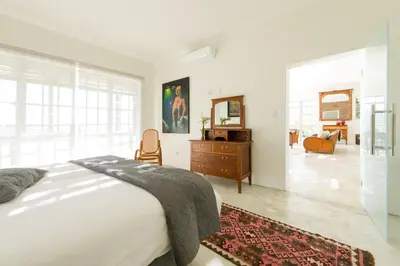 a bedroom with a bed and a dresser with a mirror at Amberg Country Estate in Paarl