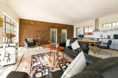 a living room with a couch and a table at Amberg Country Estate in Paarl
